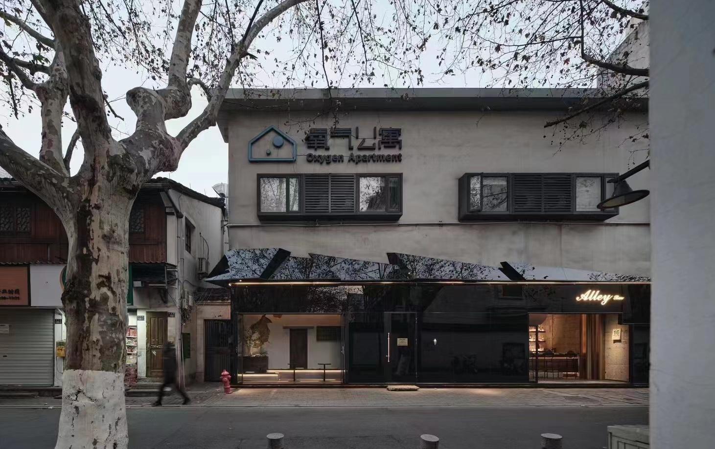 Alley bar streetfront with dark facade and warm entrance lighting
