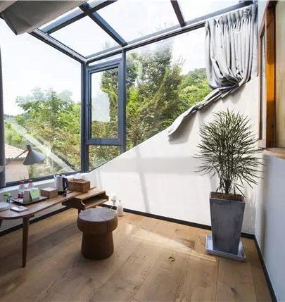 Bright balcony sitting area connected to compact boutique guest room