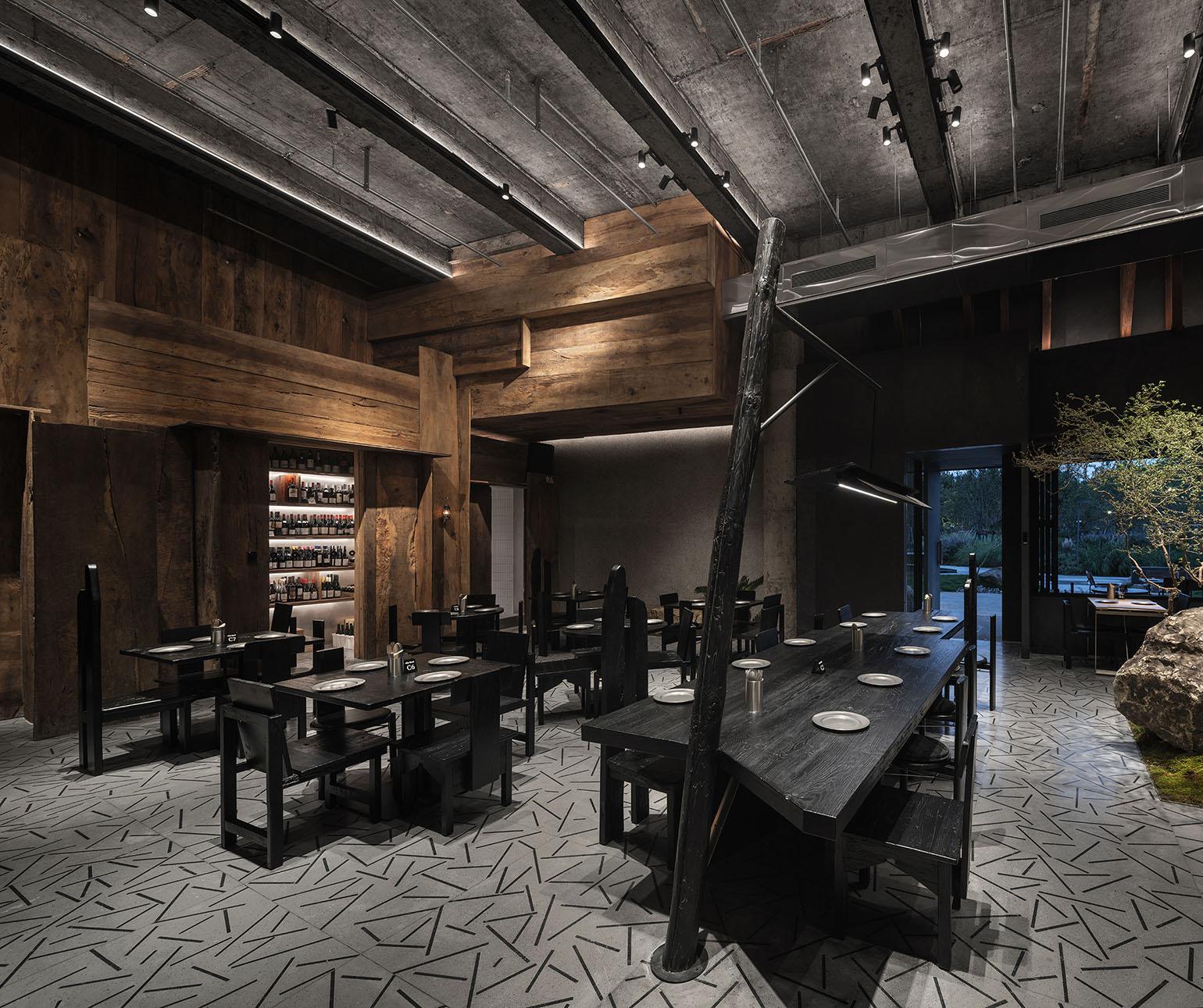 Courtyard restaurant interior with dark timber furniture and garden view