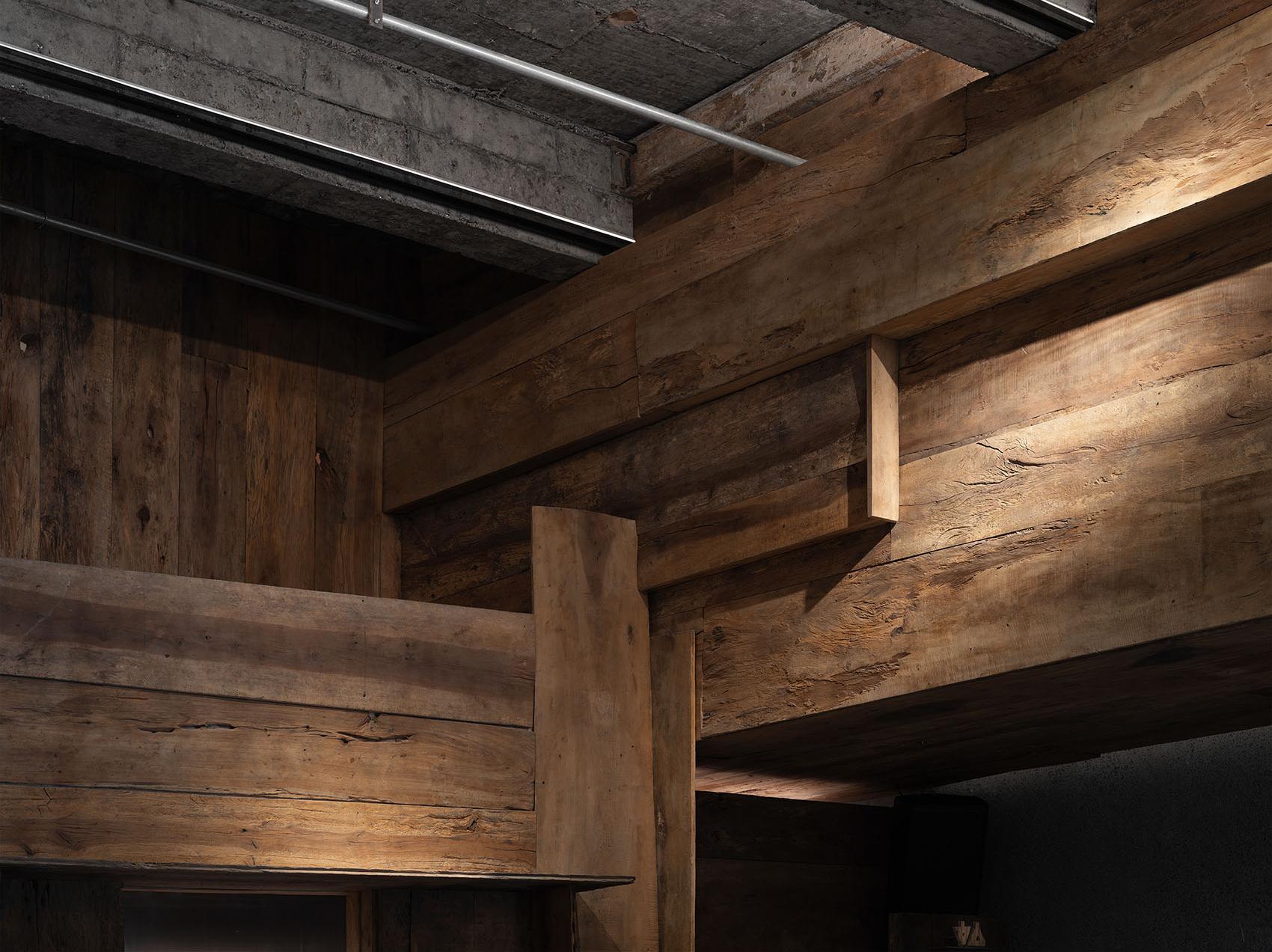 Dark timber ceiling and restaurant interior detail with warm material texture