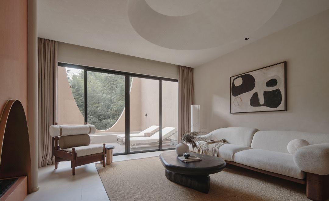 Resort guest room sitting area with large windows and soft natural light