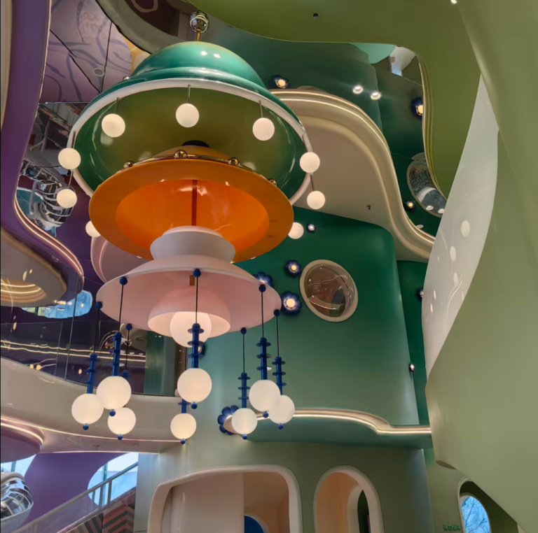 Fantasy children activity center ceiling with circular lights and green orange play forms