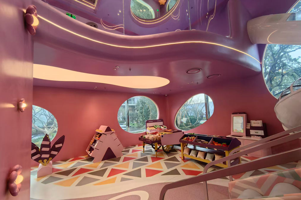 Pink children activity room with mushroom-like columns and round windows