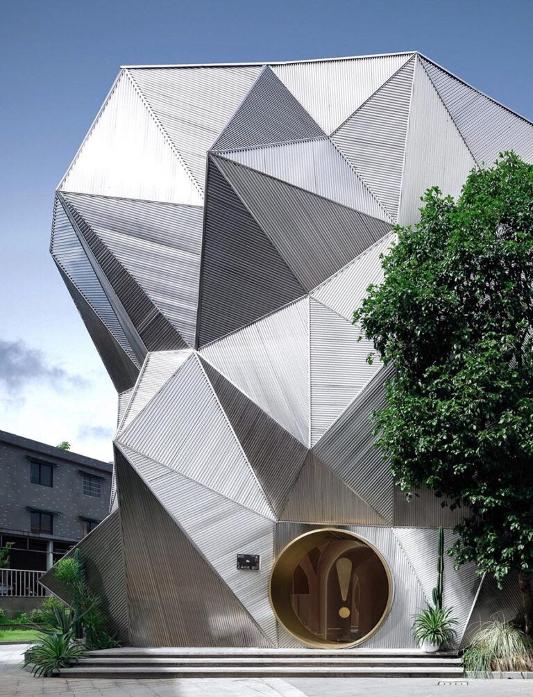 Geometric commercial gallery facade with faceted exterior cladding