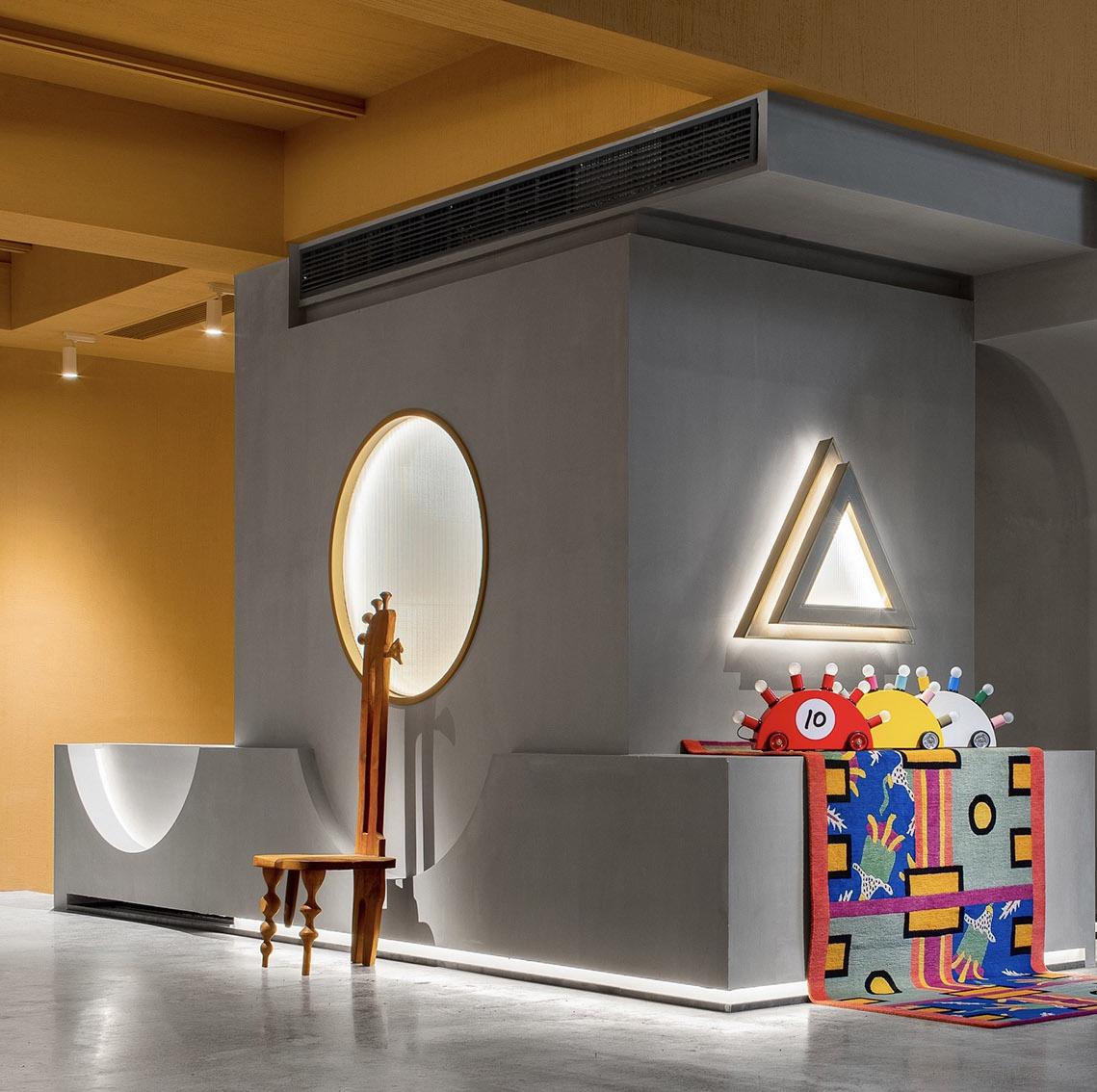 Art retail gallery interior with curved display walls and warm lighting