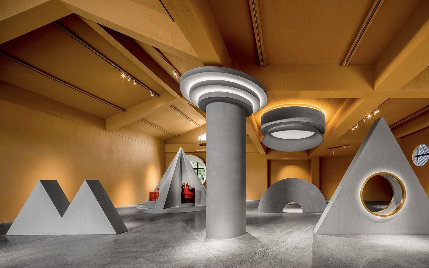 Sculptural commercial interior with circular ceiling lights and geometric wall features