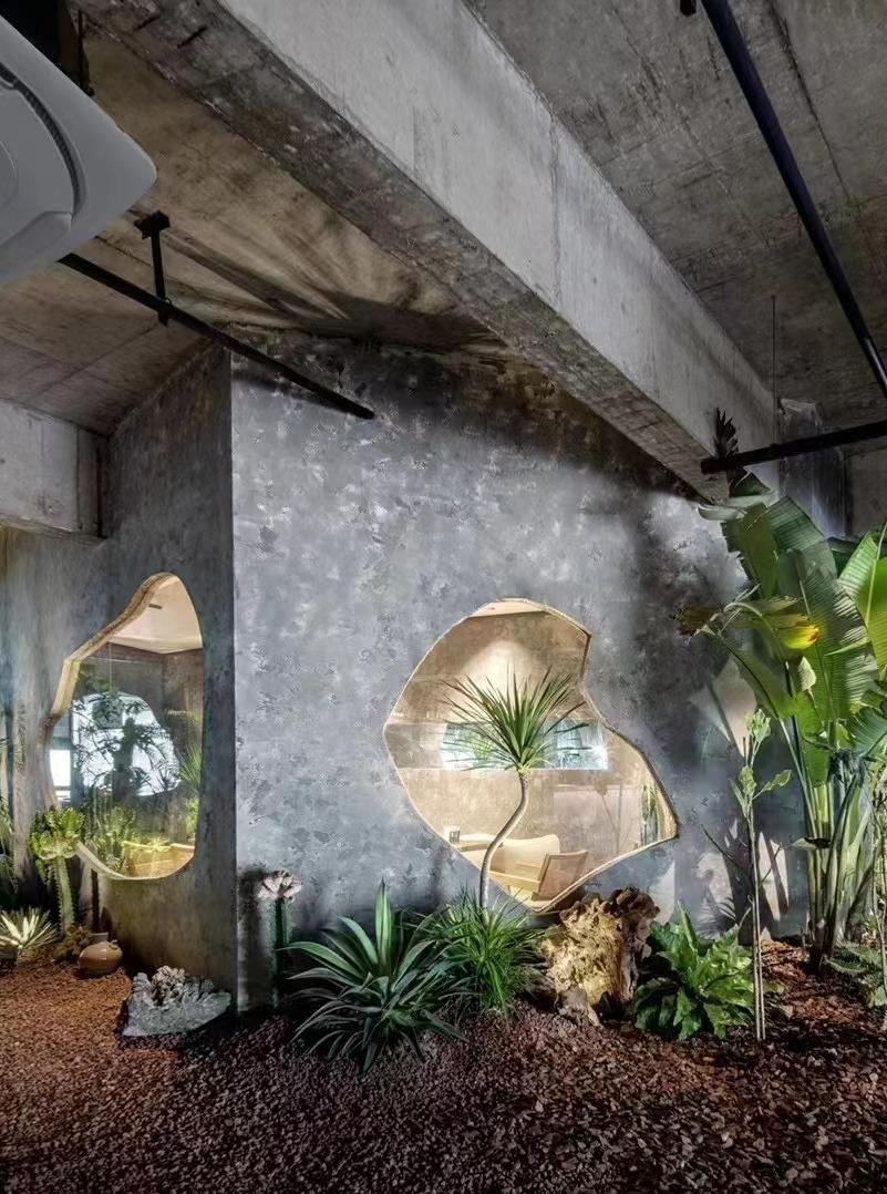 Industrial garden restaurant corner with indoor plants and textured wall feature