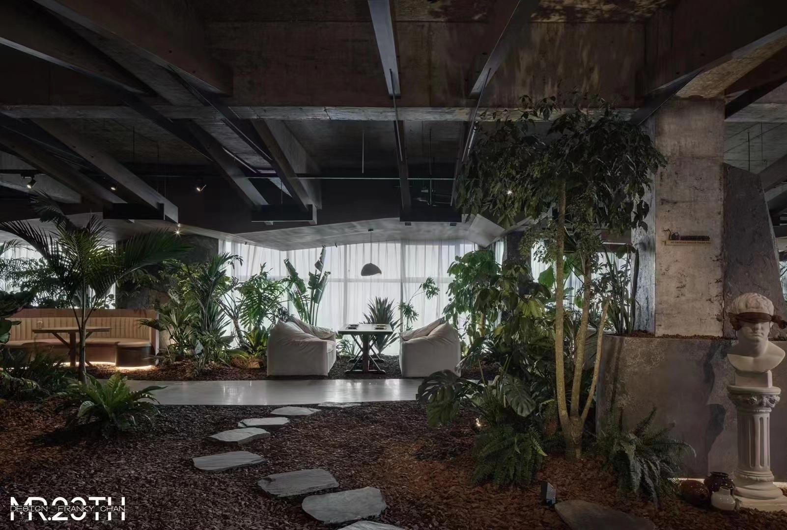 Restaurant dining interior with exposed structure, plants and warm lighting