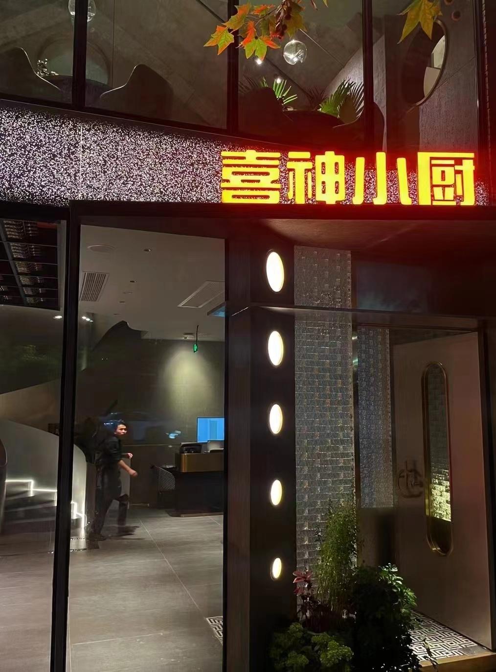 Industrial restaurant entrance with warm signage and vertical wall details