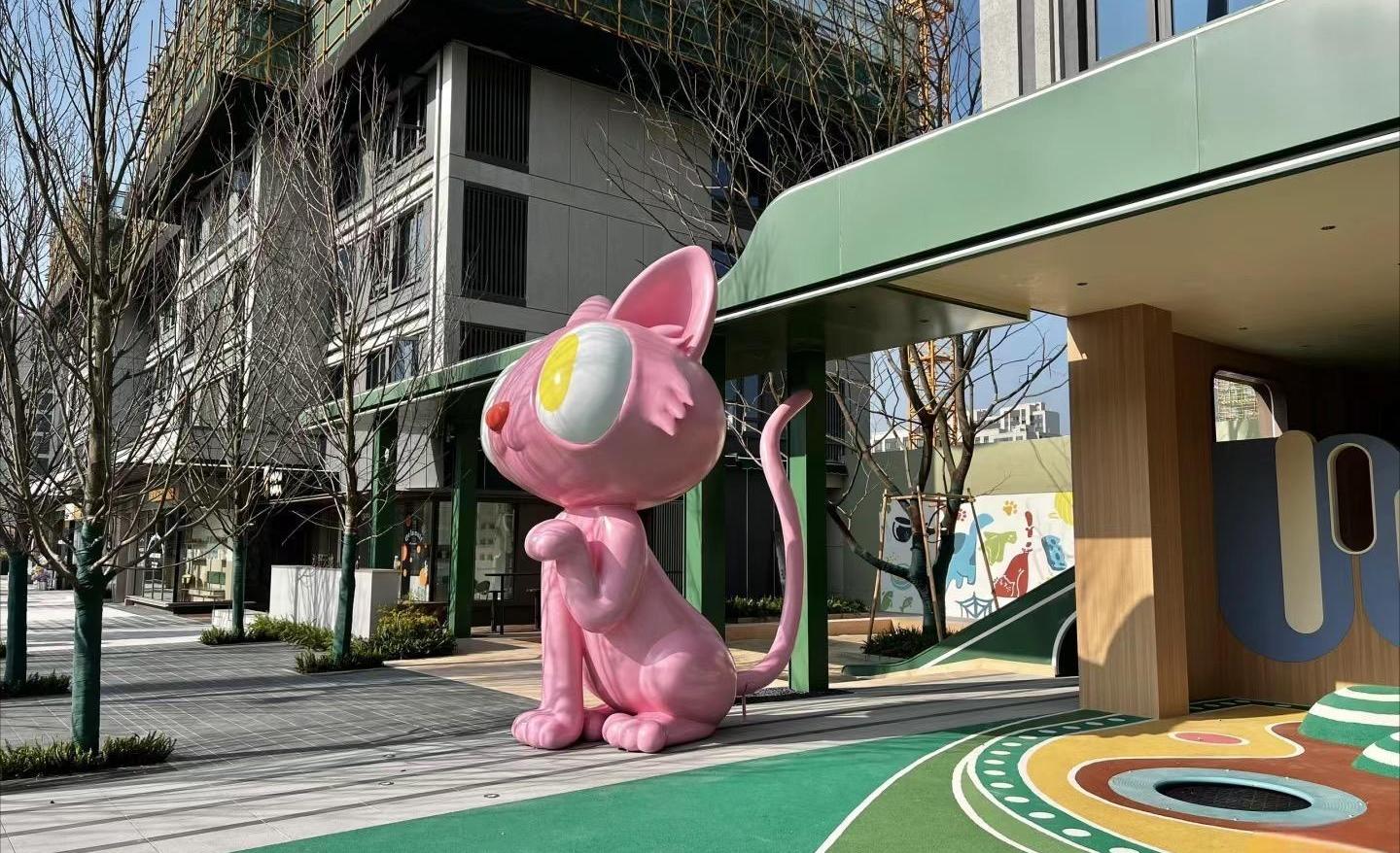 Outdoor children play landscape with sculptural animal feature and colored paving