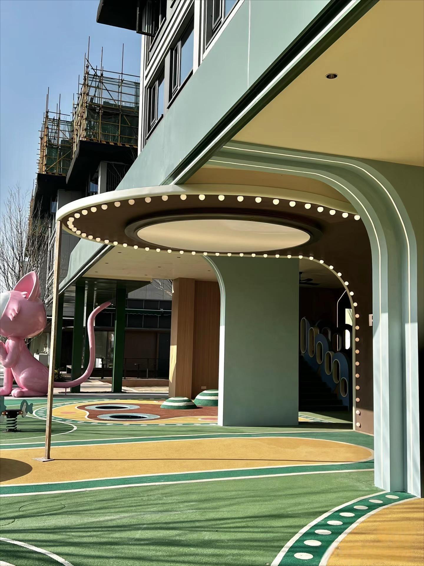 Family commercial storefront with green canopy and themed outdoor play route