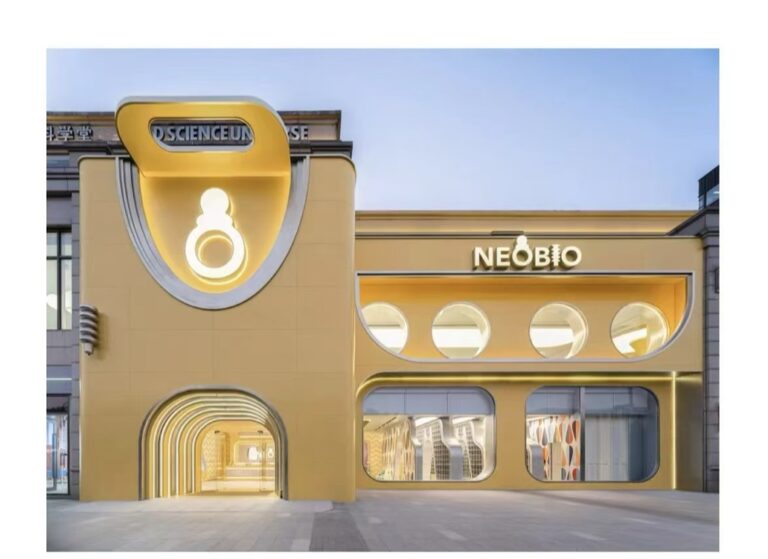 Pastel children retail storefront with rounded yellow facade and playful brand display