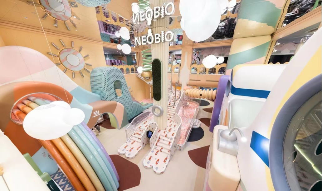 Pastel play retail space with soft archways and central display feature