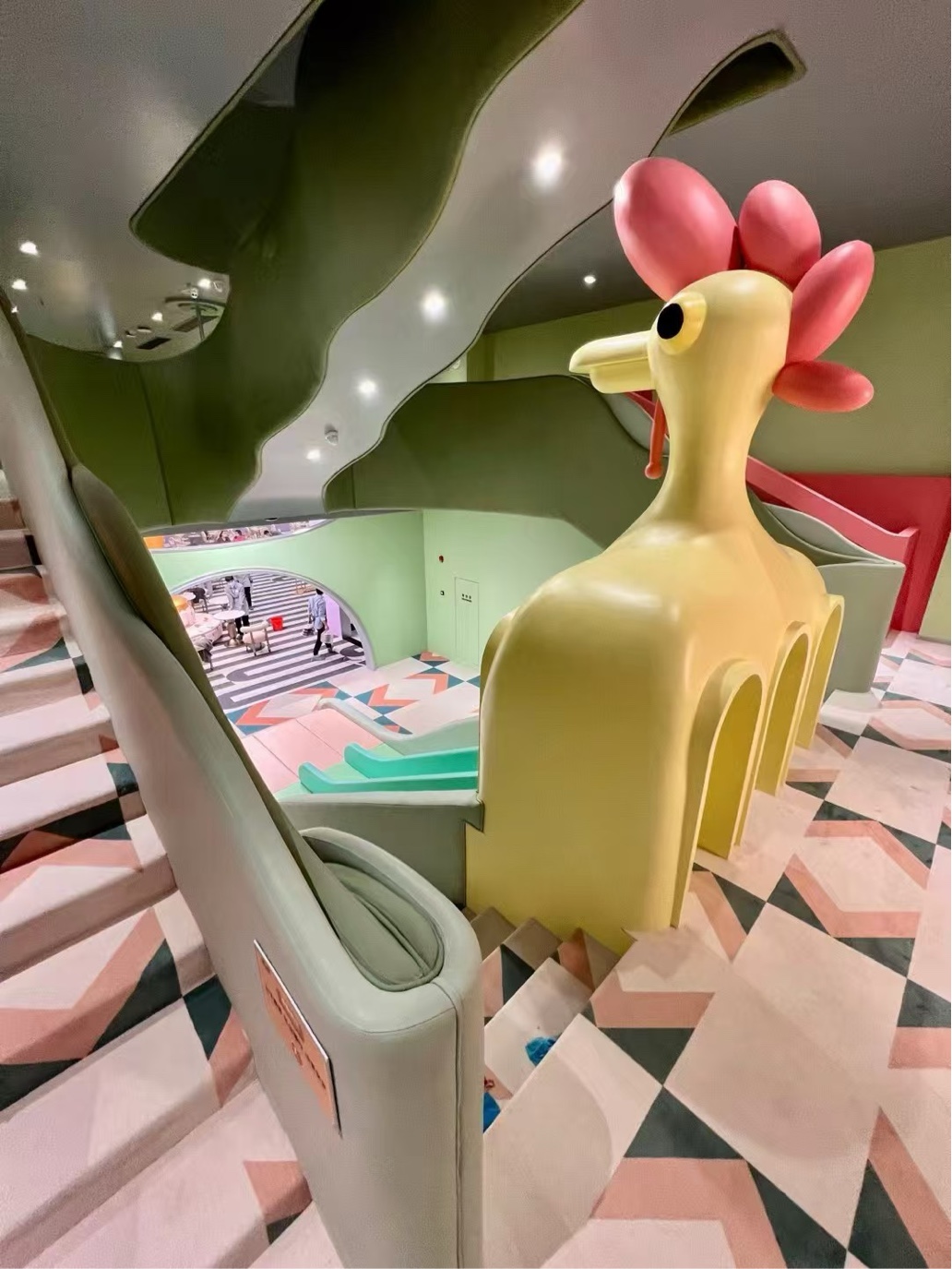 Children themed retail interior with giraffe sculpture and soft display forms