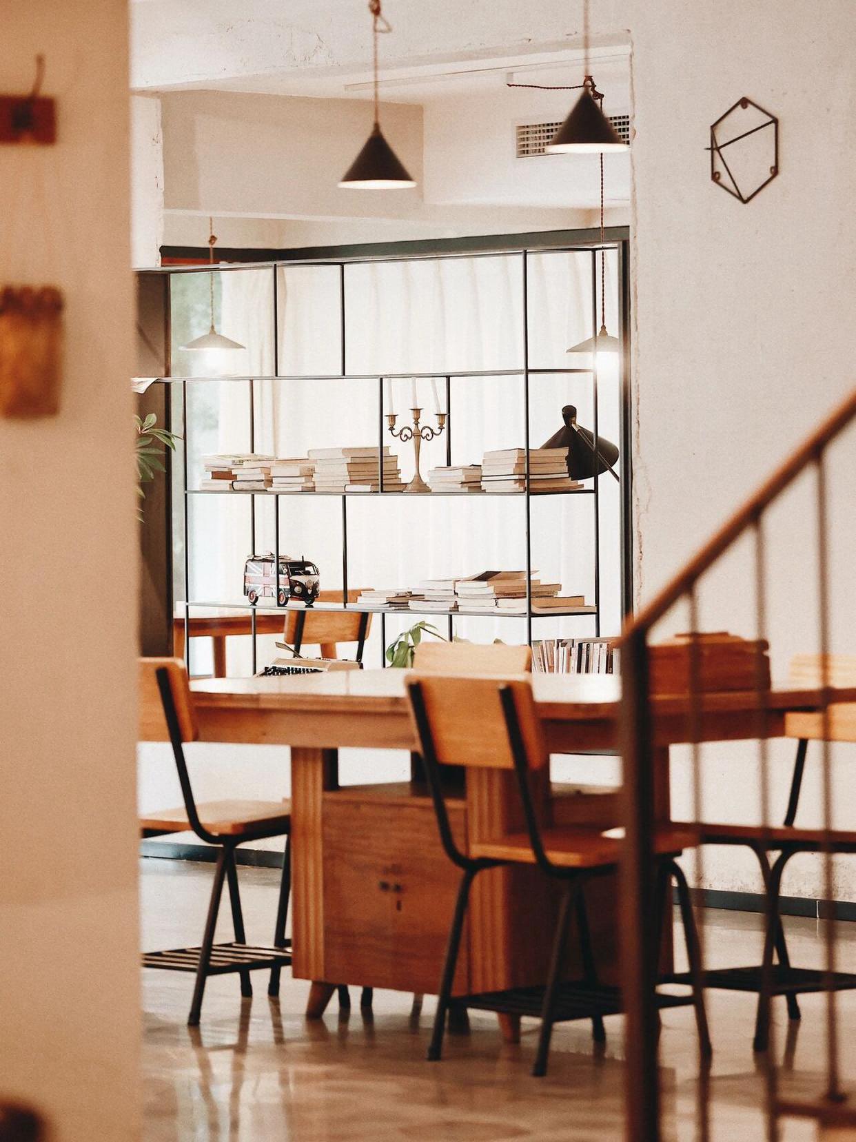 Rustic boutique homestay dining area with wood furniture and natural light