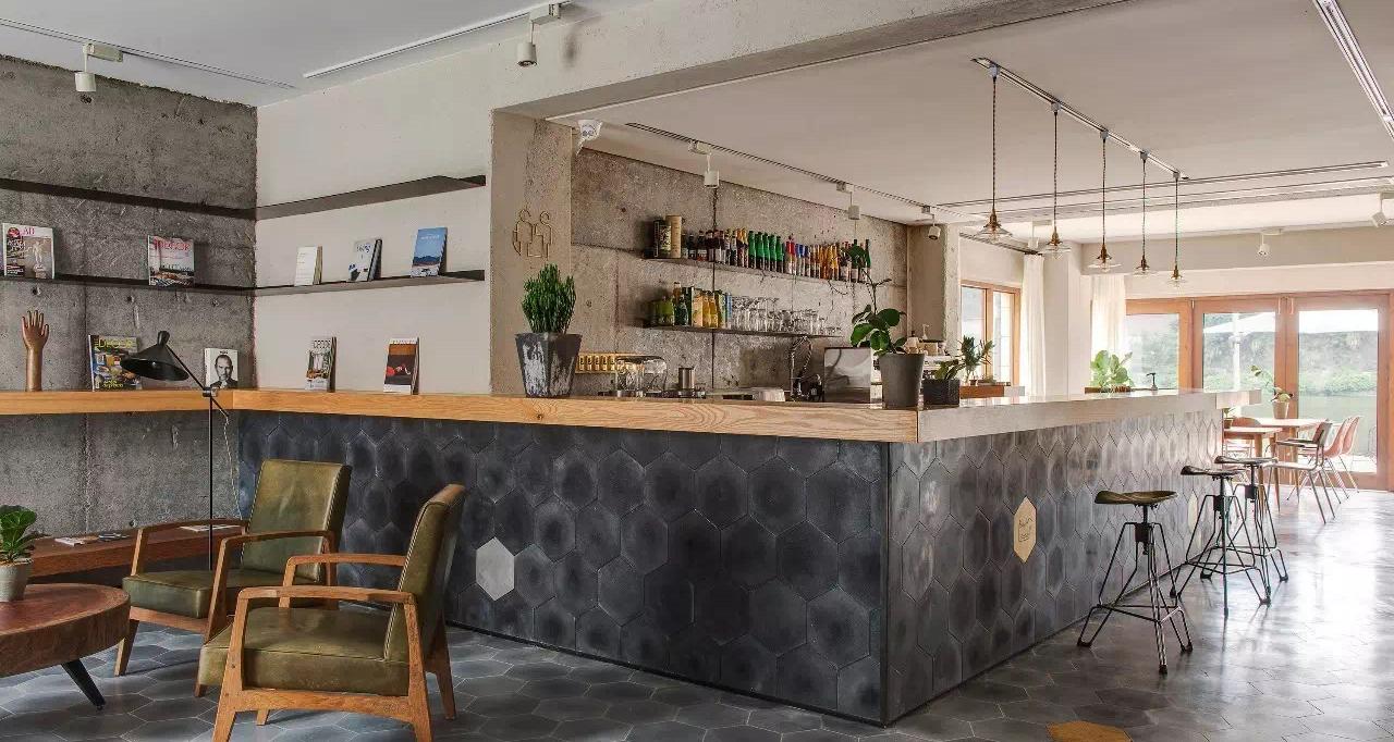 Cafe counter and open kitchen with stone front and suspended shelving